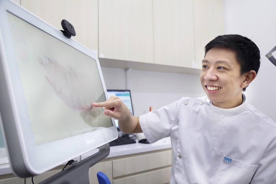 male dentist using invisalign itero intraoral scanner